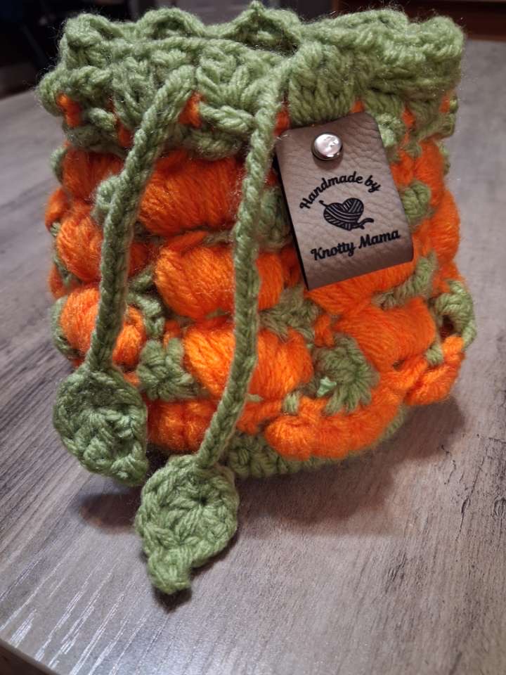 Handmade orange bobble crochet pumpkin drawstring bag with sage green trim